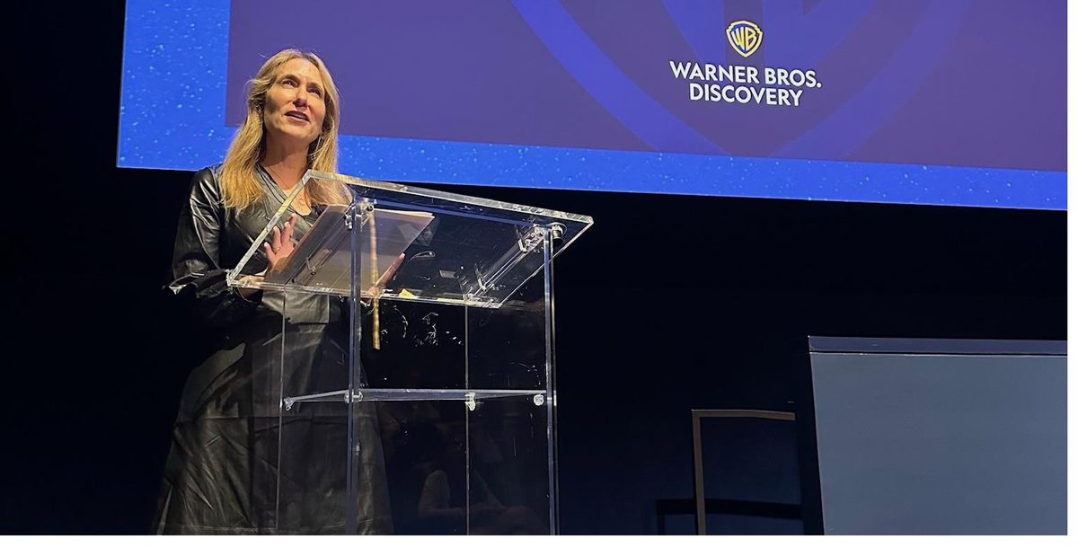 Laura speaking at a Warner Bros. Discovery event